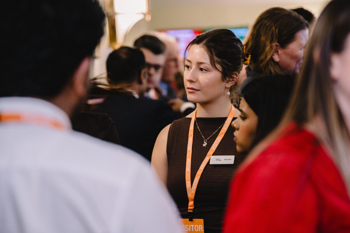 close shot of young girl in formal outfit speaking to a group of people at an event