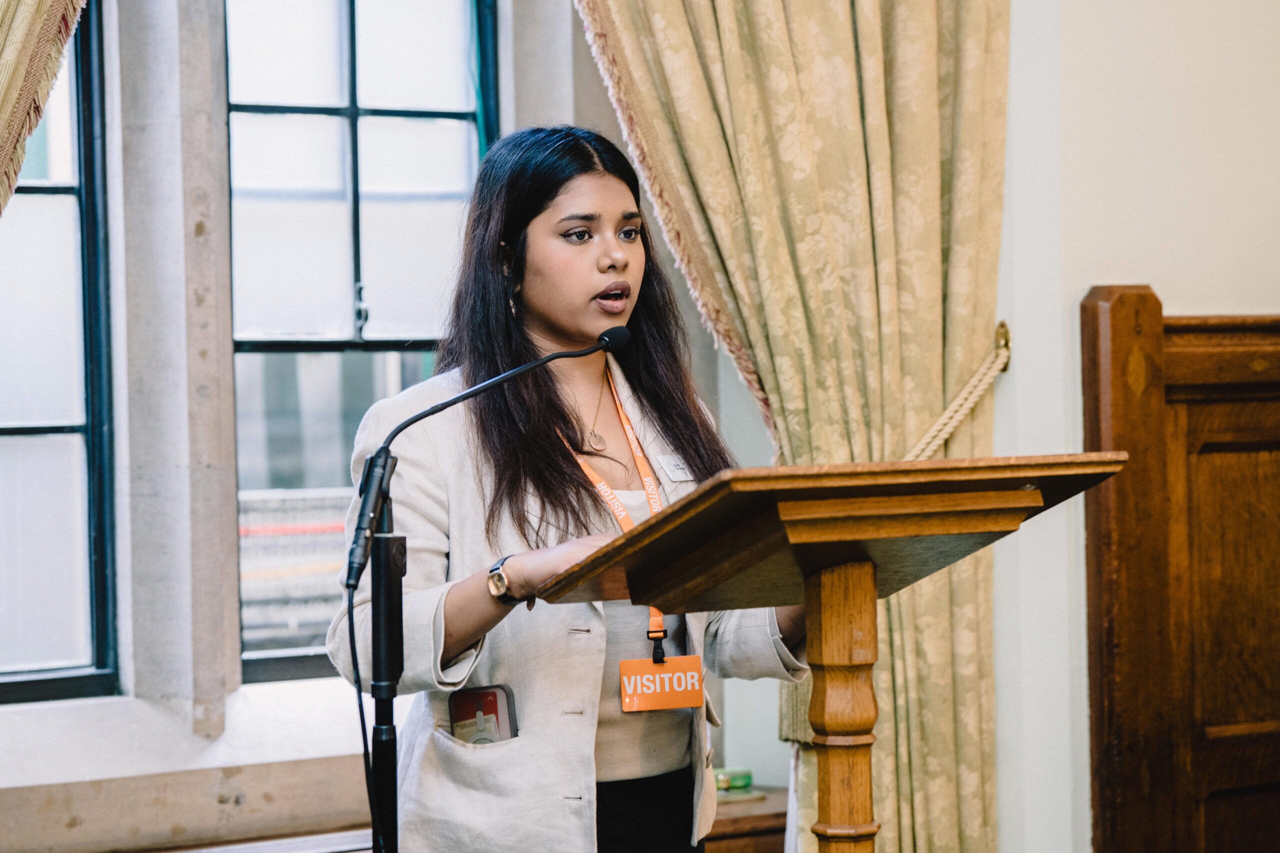 young girl dressed formally speaking at lectern